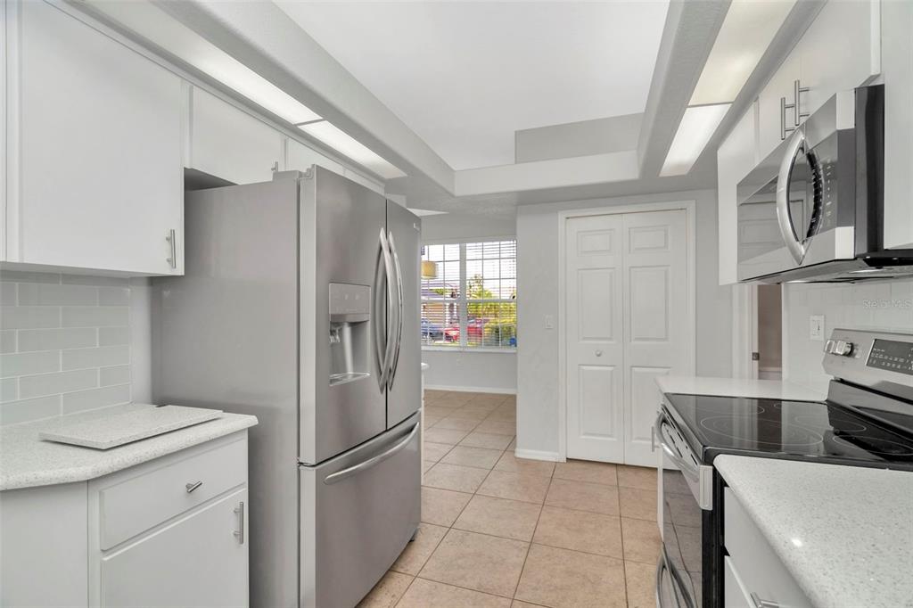 8918 Linebrook Drive Trinity, FL 34655 - Photo 10 of 50 a kitchen with stainless steel appliances granite countertop a refrigerator a stove top oven a sink and dishwasher