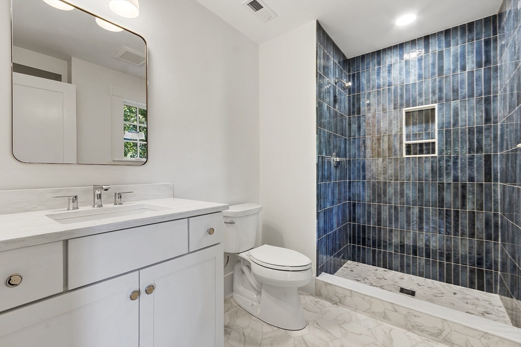 140 Revolutionary Road Concord, MA 01742 - Photo 30 of 41 a bathroom with a sink toilet and shower