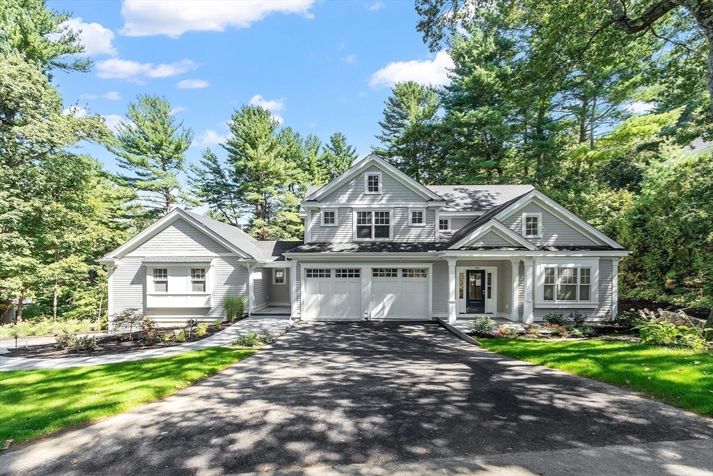 140 Revolutionary Road Concord, MA 01742 - Photo 3 of 41 a front view of a house with a garden and trees