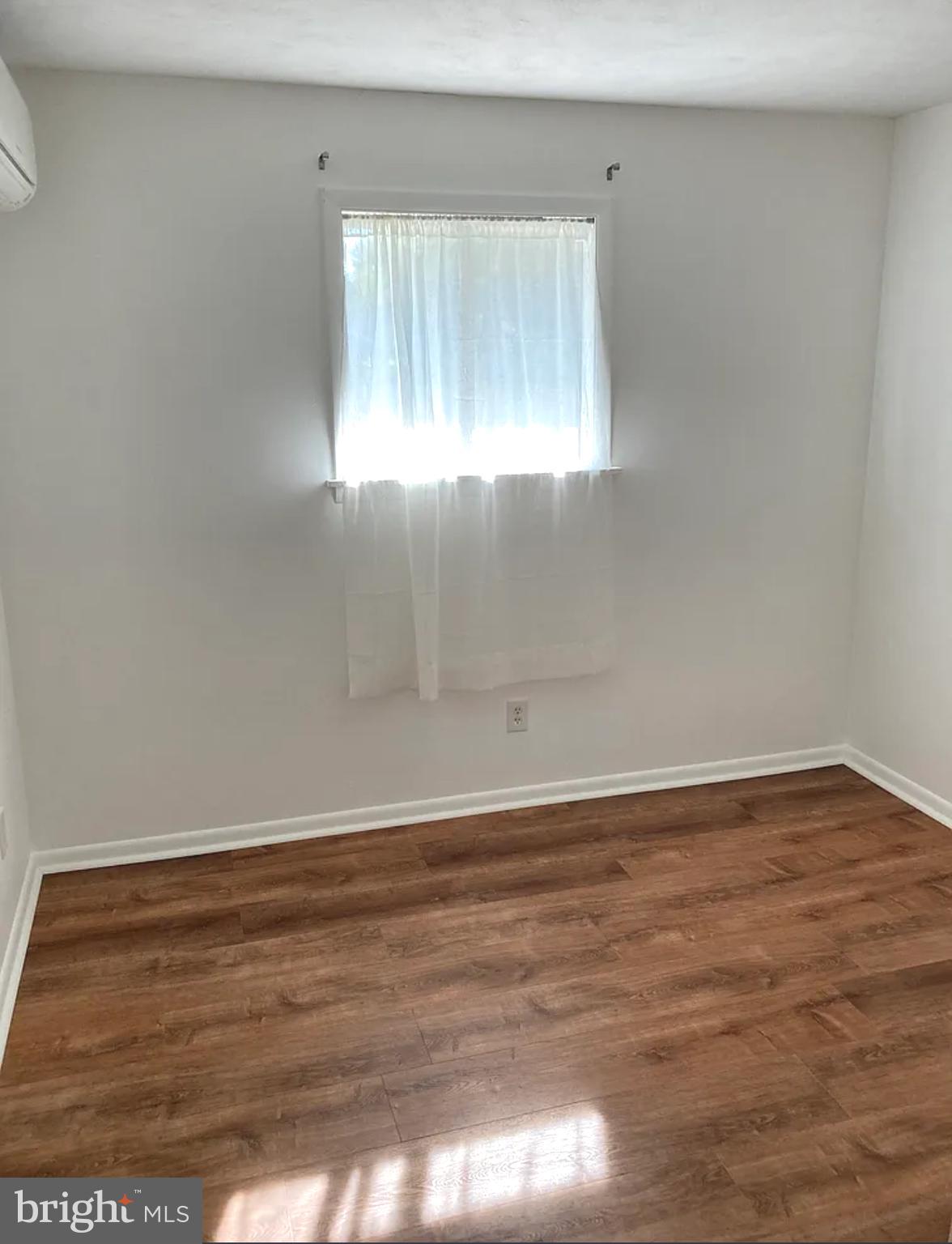 397 Vesper Road Hershey, PA 17033 - Photo 13 of 19 a view of an empty room with wooden floor and window