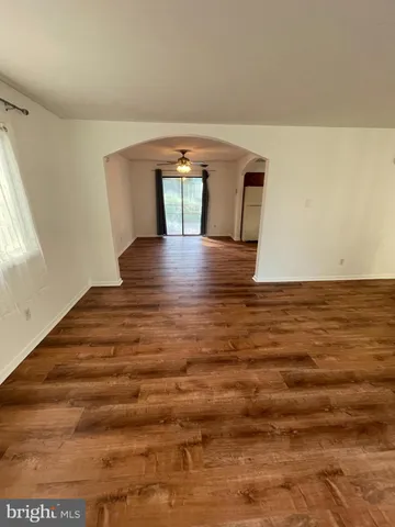 a view of room with window and wooden floor