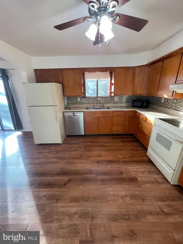 a kitchen with stainless steel appliances kitchen island granite countertop a sink and cabinets