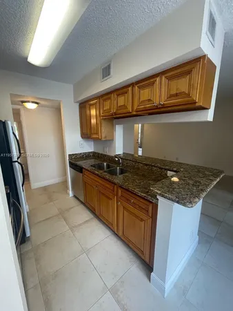 a kitchen with stainless steel appliances granite countertop a stove and a sink