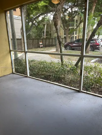 a view of a room with a large tree and a lawn chair