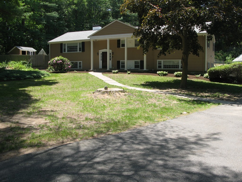 7 Mohawk Road Canton, MA 02021 - Photo 1 of 19 a front view of a house with a yard and garage