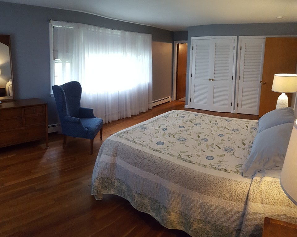 7 Mohawk Road Canton, MA 02021 - Photo 8 of 19 a bedroom with a bed and chair