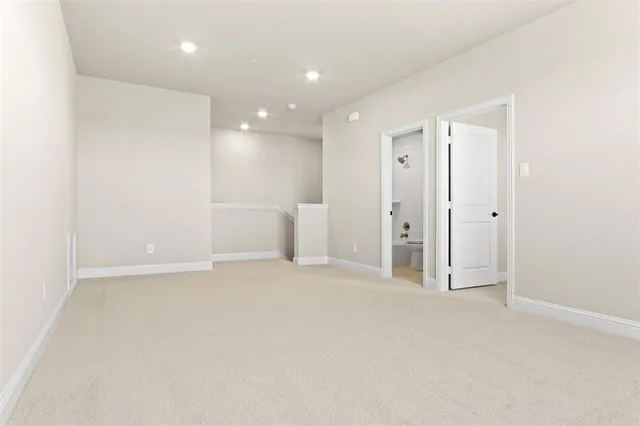 a bathroom with a granite countertop sink a toilet and shower