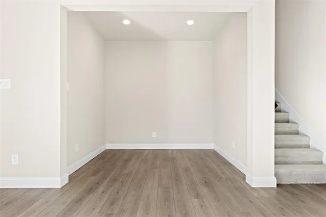 a view of a room with wooden floors and led lights