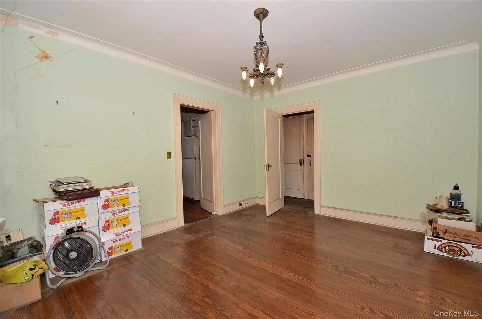 2586 Riverside Drive Wantagh, NY 11793 - Photo 10 of 28 Dining Room featuring a solid wood door, hardwood flooring, and crown molding