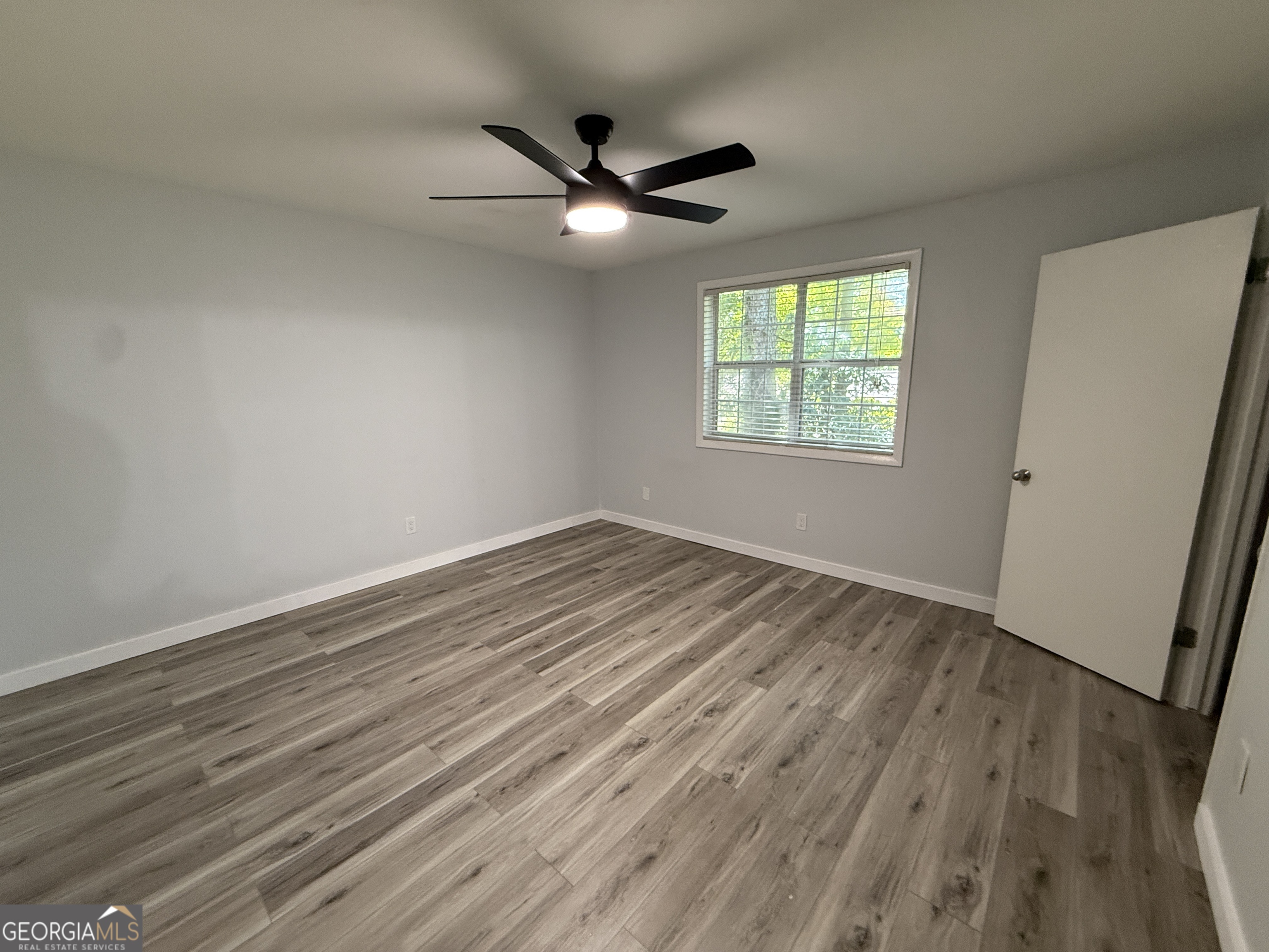 6900 Roswell Road, Unit K8 Sandy Springs, GA 30328 - Photo 13 of 30 wooden floor in an empty room with a window