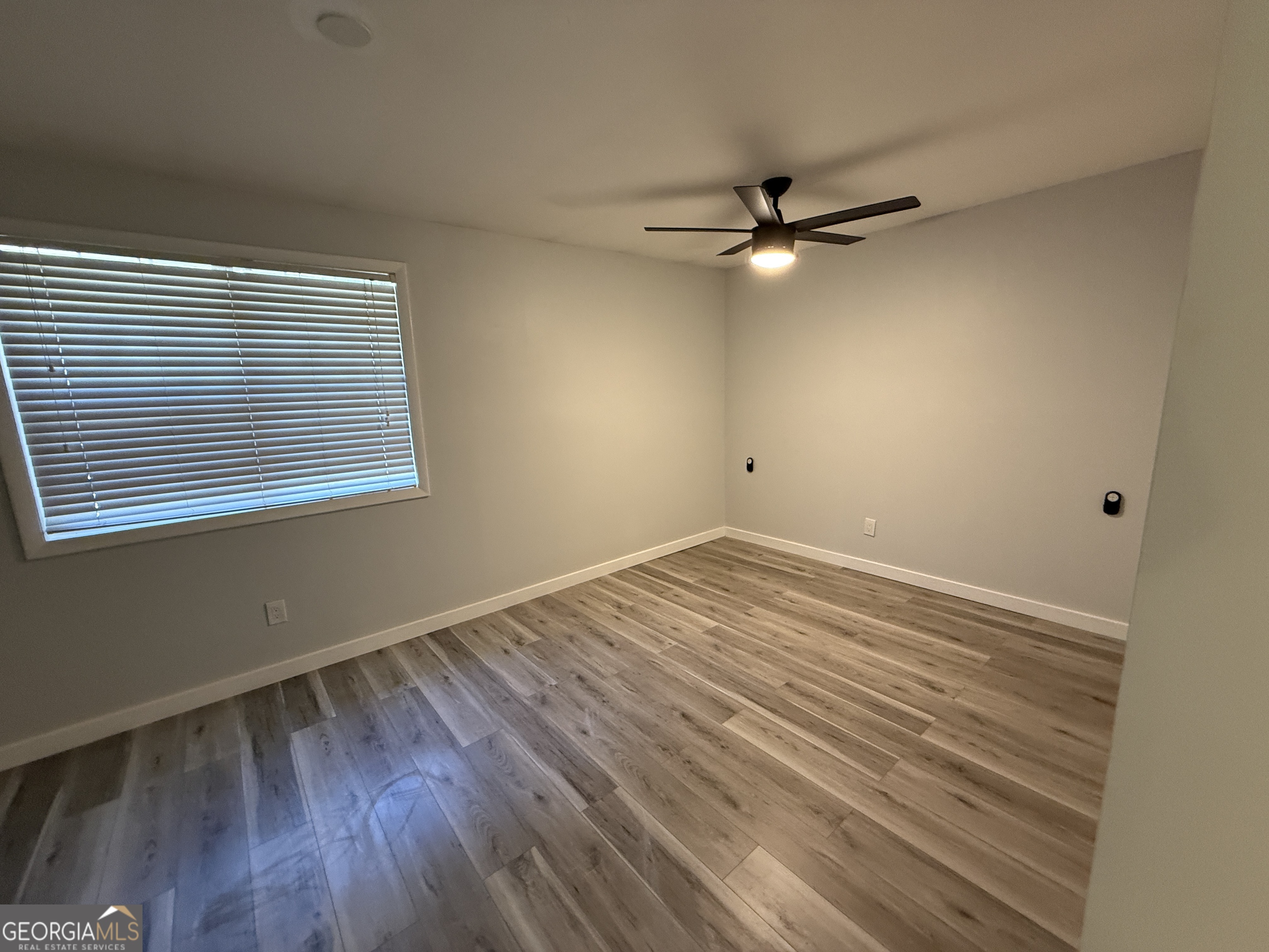 6900 Roswell Road, Unit K8 Sandy Springs, GA 30328 - Photo 14 of 30 wooden floor in an empty room with a window