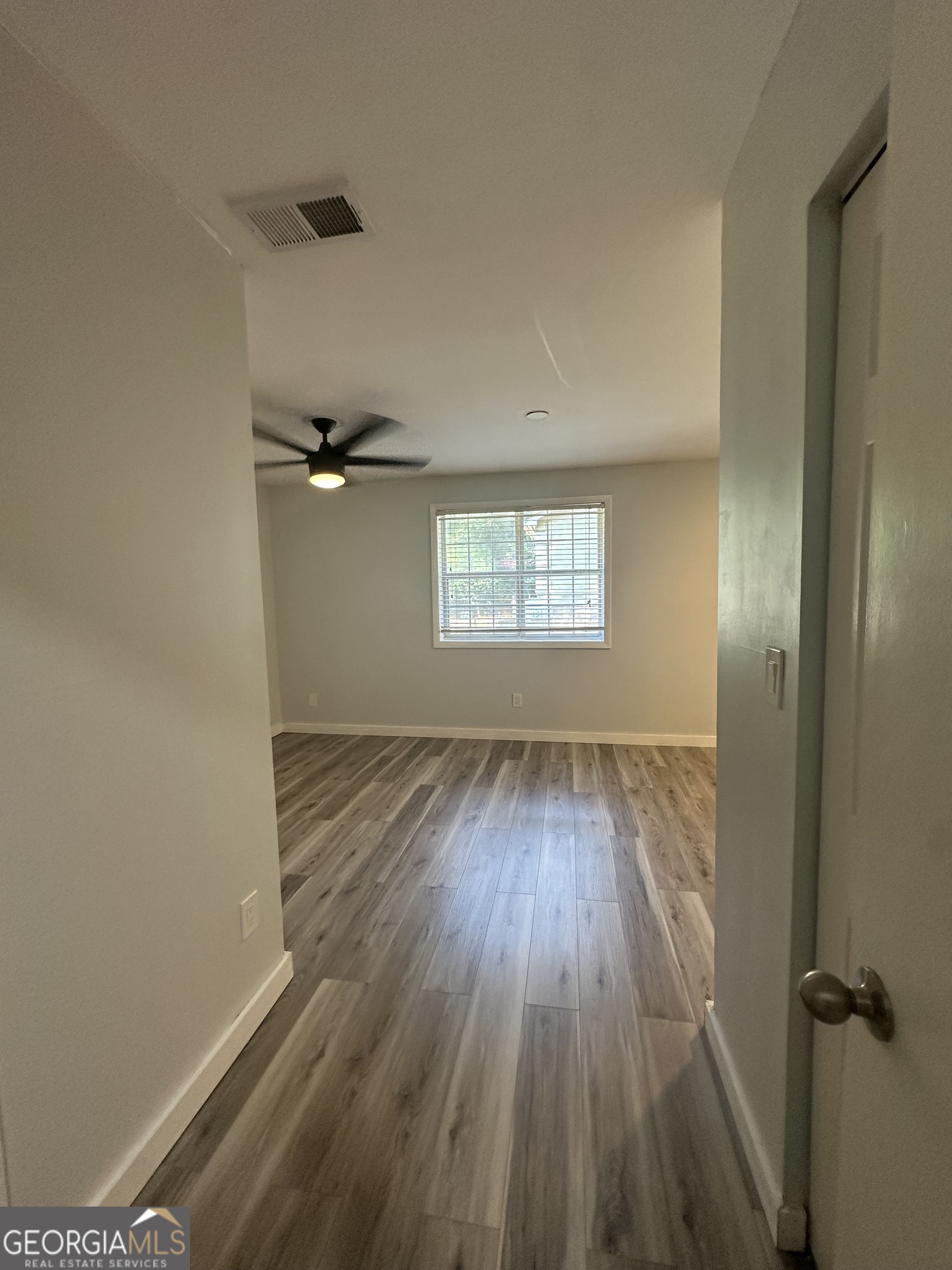 6900 Roswell Road, Unit K8 Sandy Springs, GA 30328 - Photo 16 of 30 wooden floor in an empty room with a window