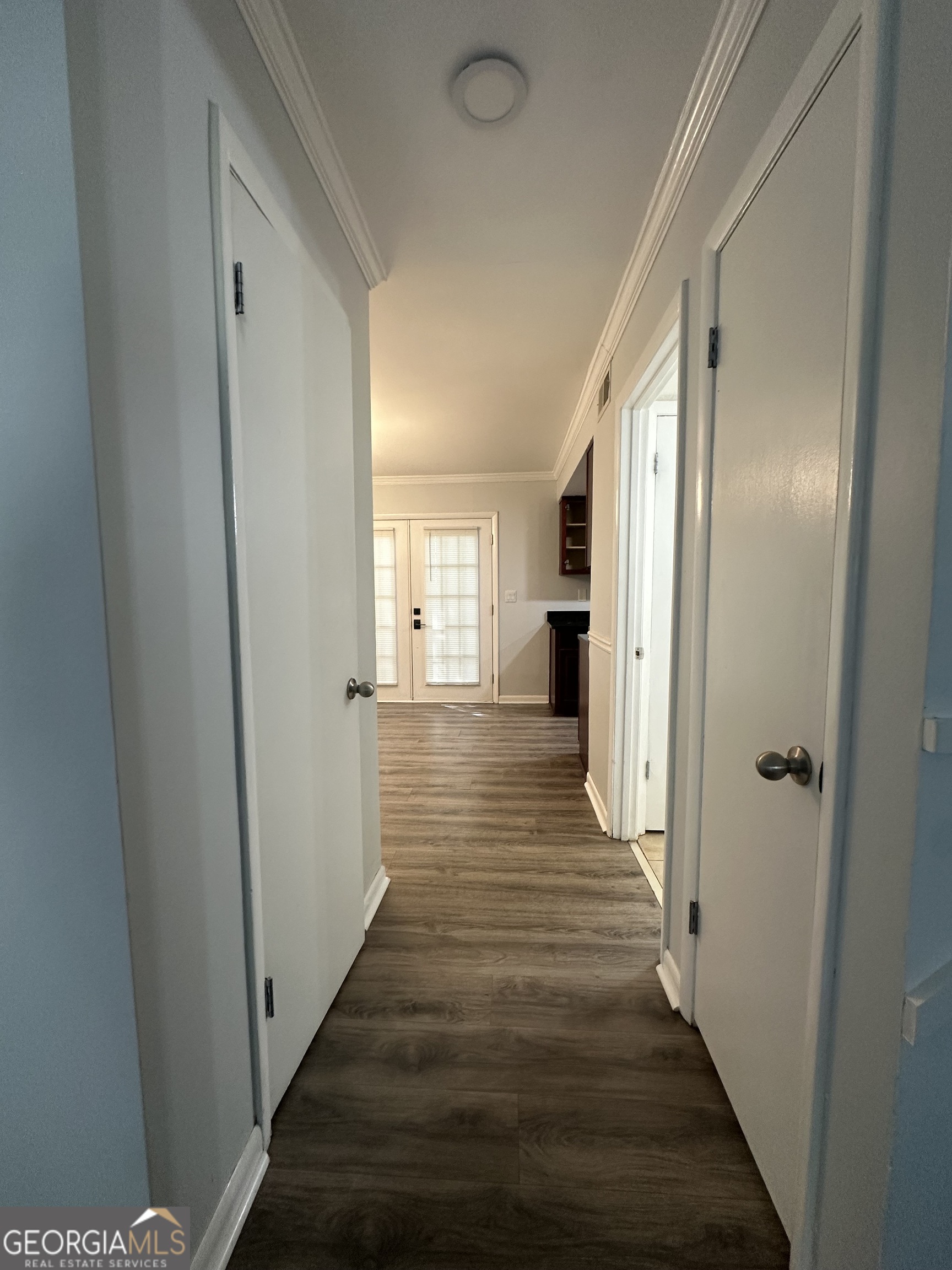 6900 Roswell Road, Unit K8 Sandy Springs, GA 30328 - Photo 18 of 30 a view of a hallway with wooden floor and staircase