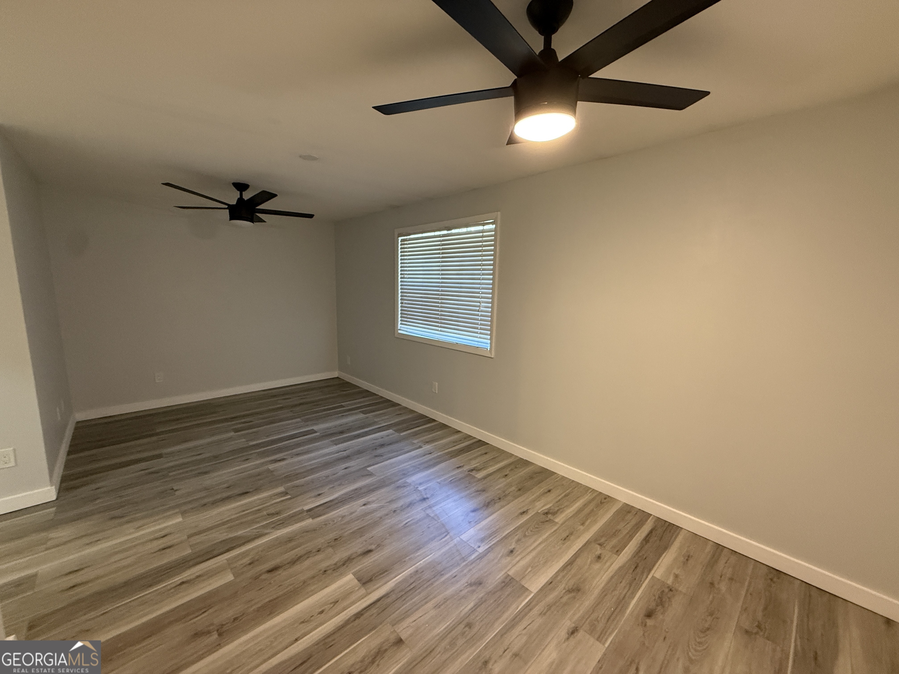 6900 Roswell Road, Unit K8 Sandy Springs, GA 30328 - Photo 19 of 30 wooden floor in an empty room