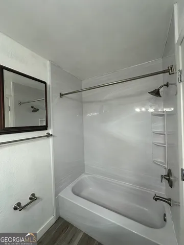 a bathroom with a tub and shower