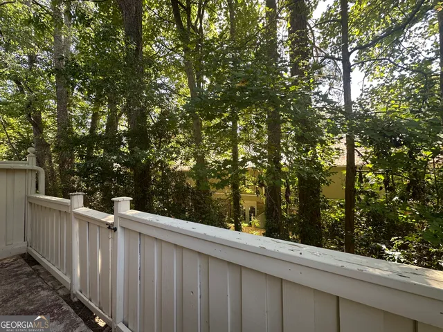 a view of a wooden fence and trees
