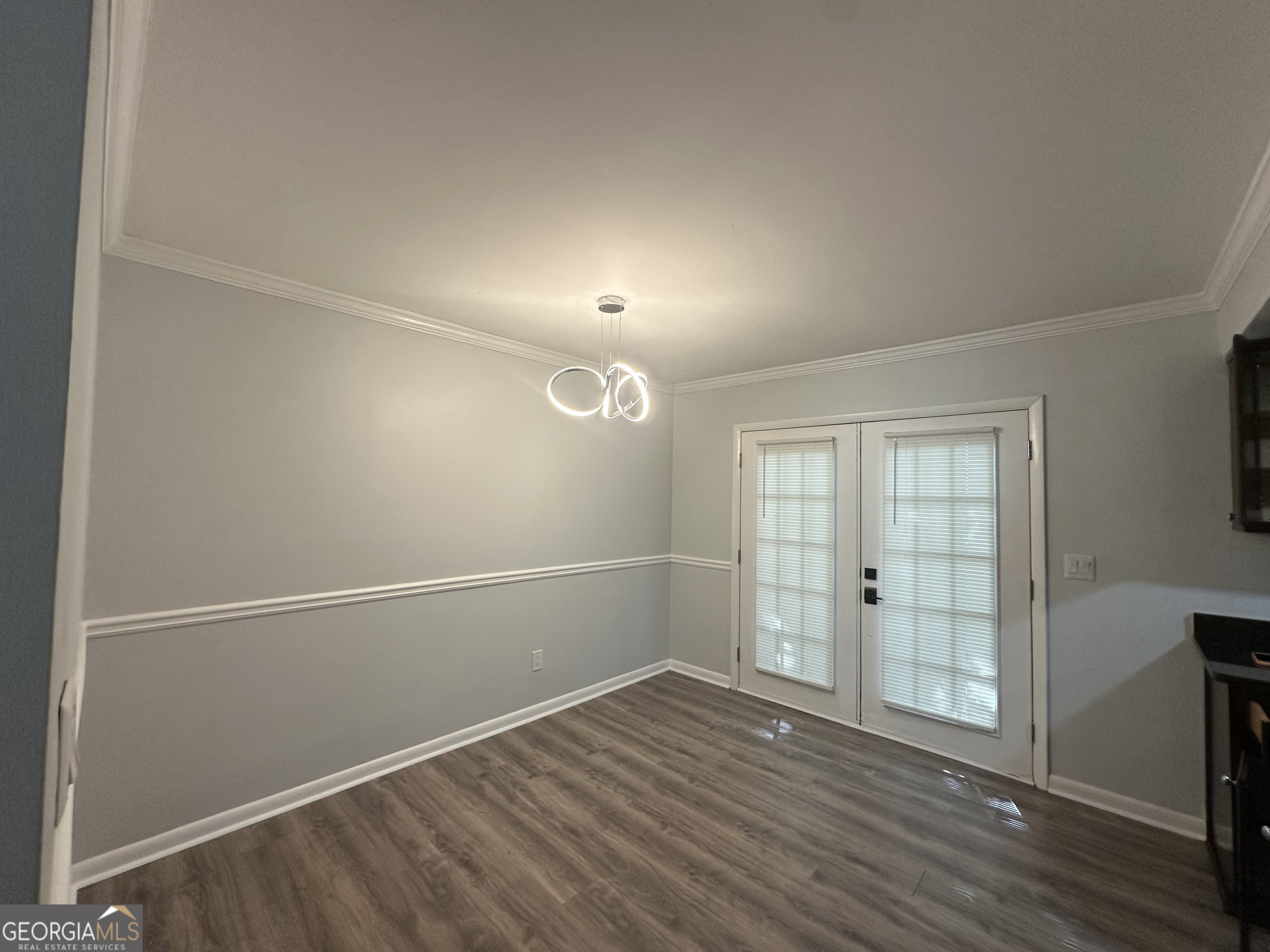6900 Roswell Road, Unit K8 Sandy Springs, GA 30328 - Photo 7 of 30 an empty room with wooden floor and windows
