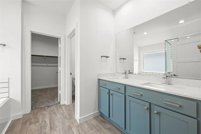a bathroom with a double vanity sink and mirror