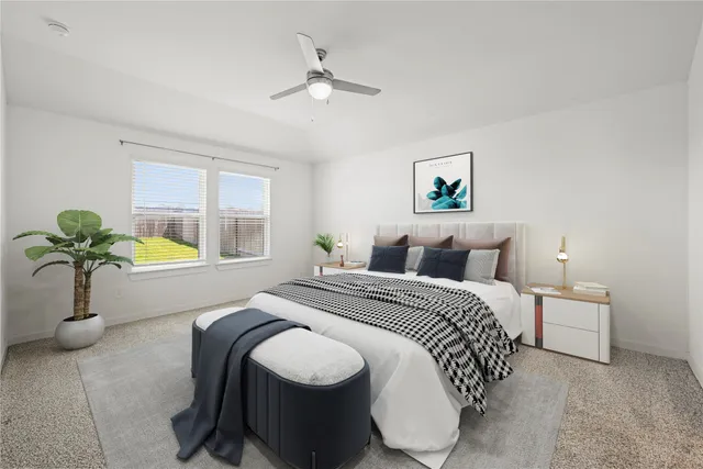 a bedroom with bed and two mirrors