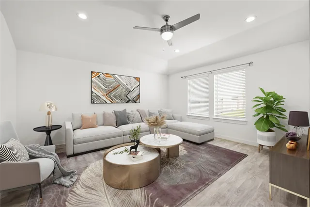 a living room with furniture potted plant and a chandelier