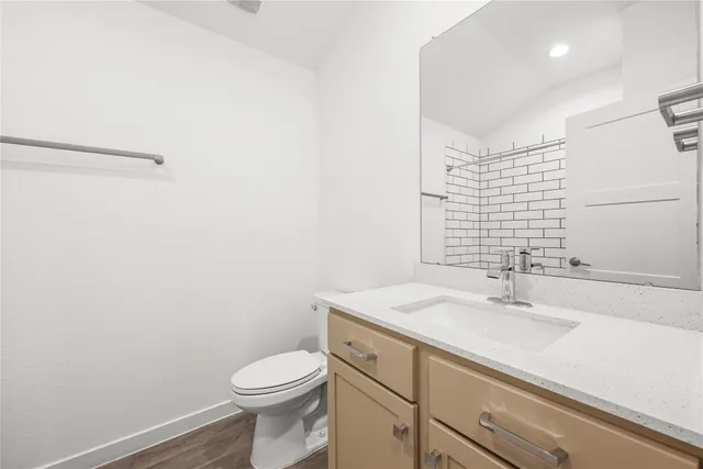 a bathroom with a sink a toilet and vanity