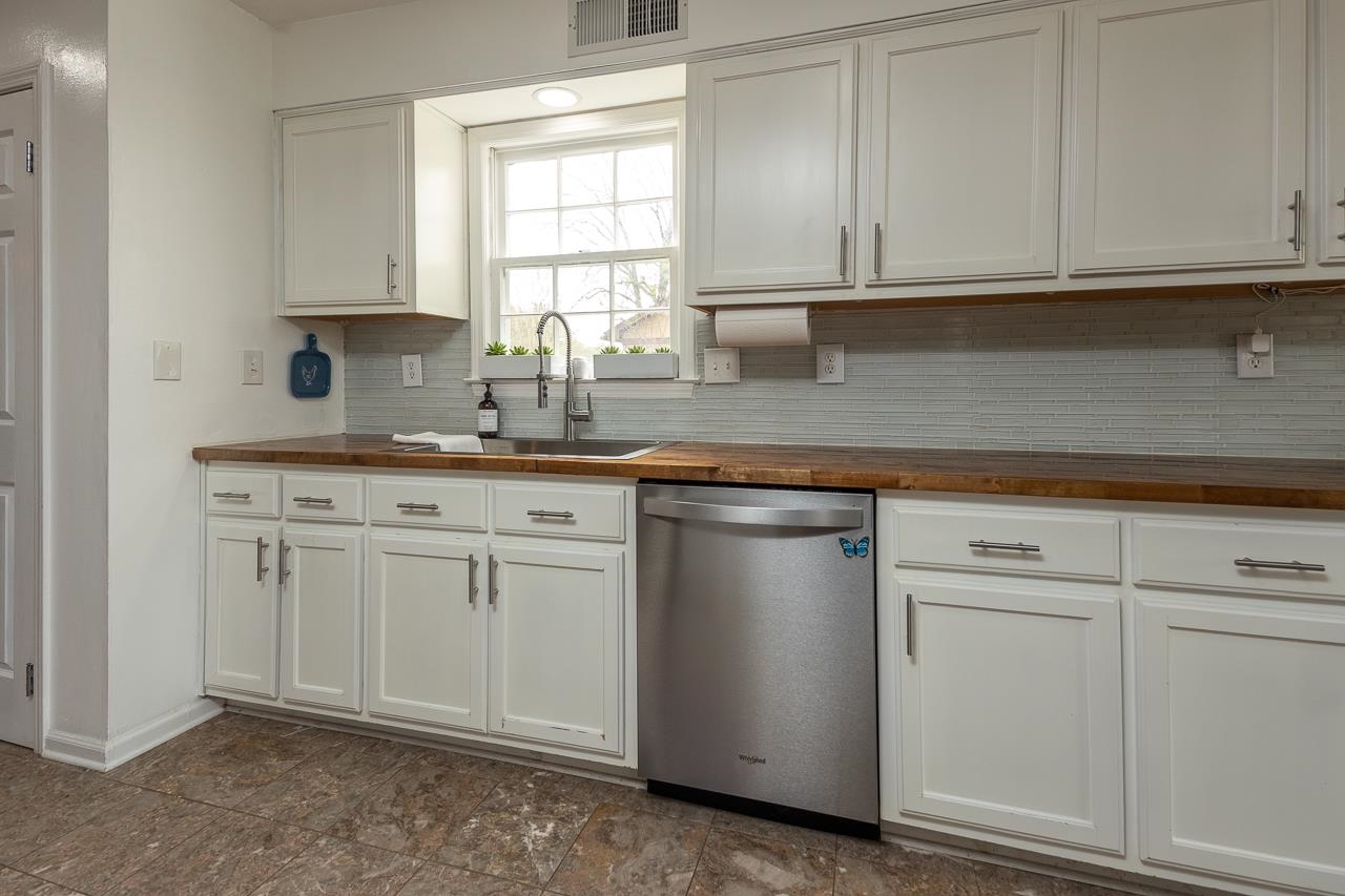 2225 Webbing Drive Memphis, TN 38016 - Photo 13 of 25 a kitchen with white cabinets and white appliances