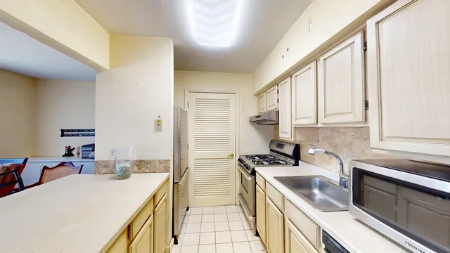 a kitchen that has a sink and a stove in it