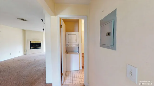 a view of a hallway with a livingroom and a bathroom