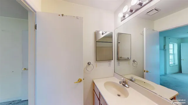 a bathroom with a sink and mirror