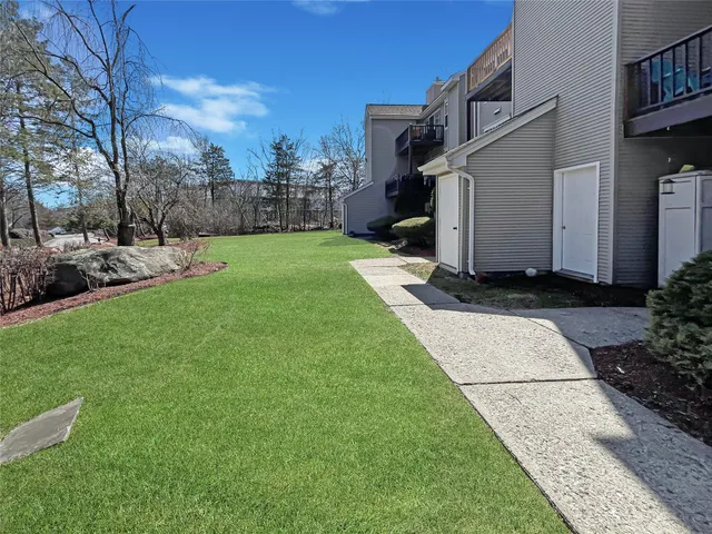 a front view of a house with a yard and trees