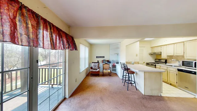 a view of a kitchen with furniture and a window