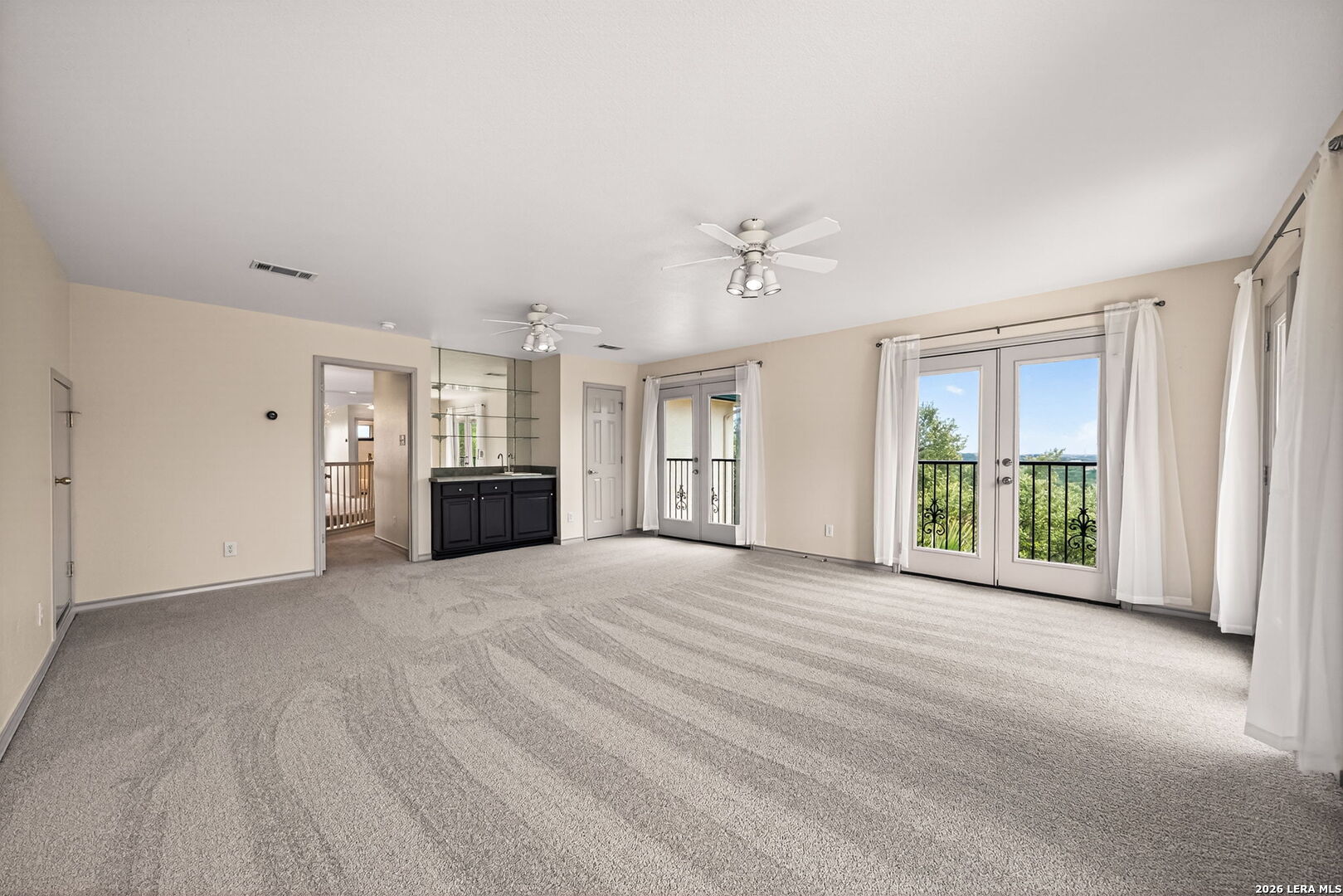 17431 Helotes Spring Road Helotes, TX 78023 - Photo 36 of 50 a view of an empty room with a window and fireplace