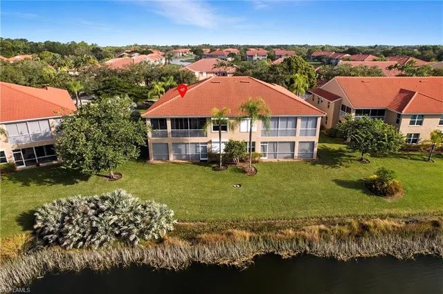 an aerial view of a house with a garden and swimming pool