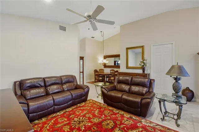 a living room with furniture a rug and a chandelier