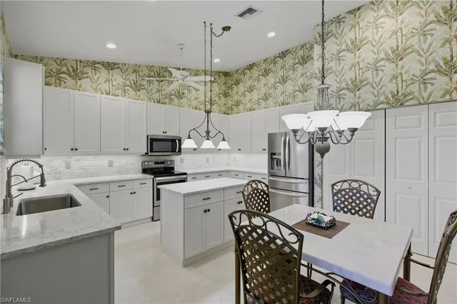 a kitchen with a sink a counter space and appliances