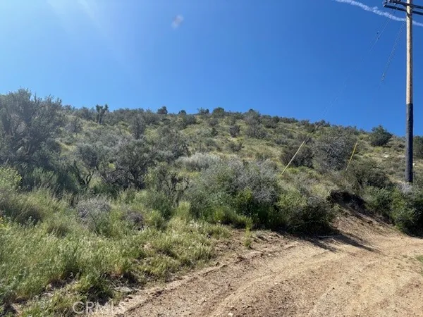 a view of a large building with mountains in the background