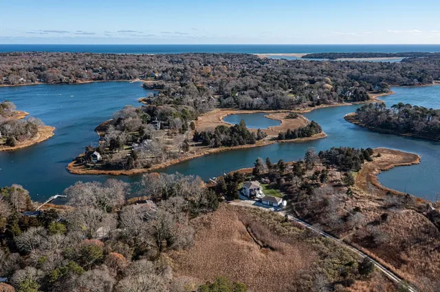 an aerial view of a house with garden space and ocean view
