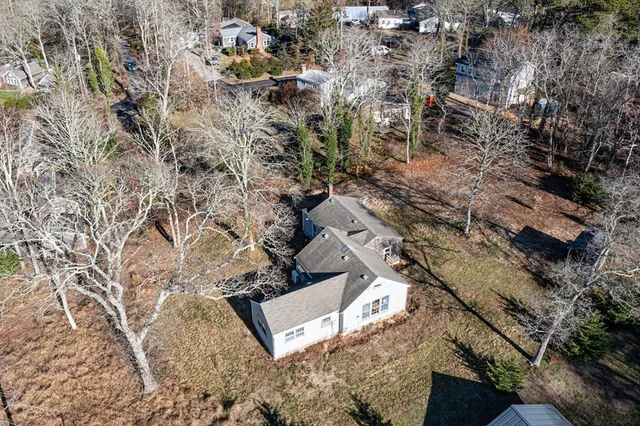an aerial view of a house with a yard