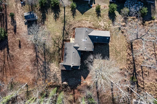 a view of house with yard and trees