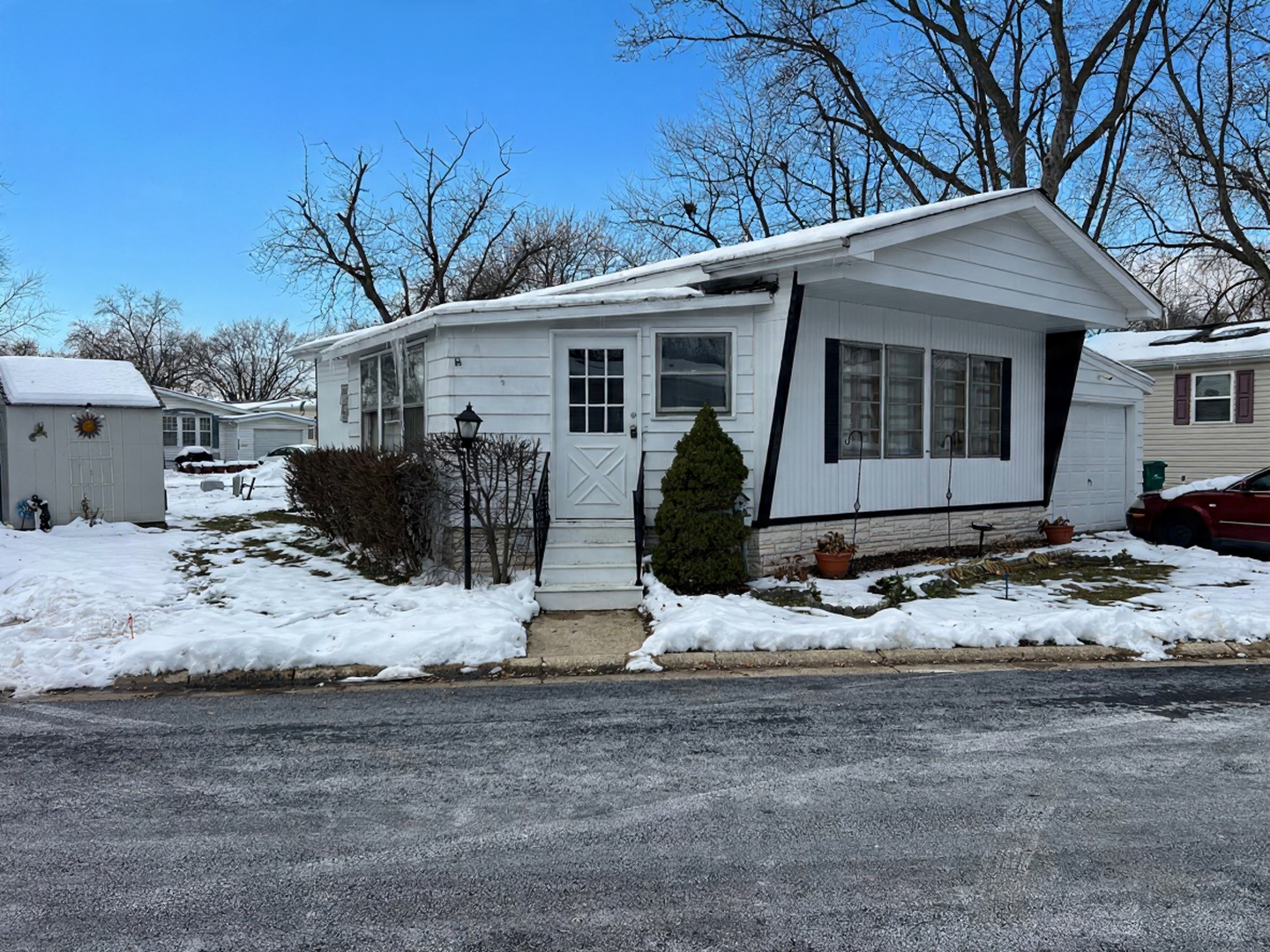 1178 Country Club Road Elgin, IL 60123 - Photo 1 of 7 a view of a house with a yard covered in snow