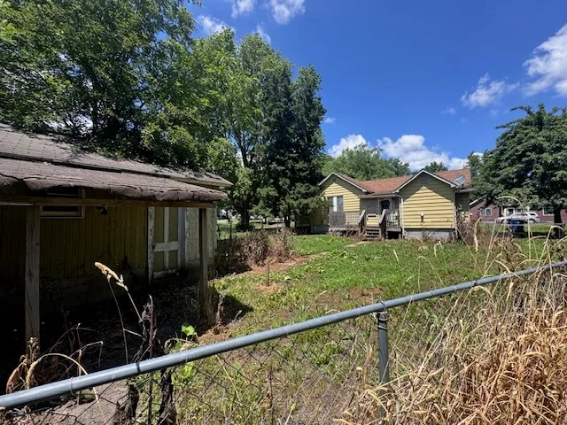 a view of a house with wooden fence