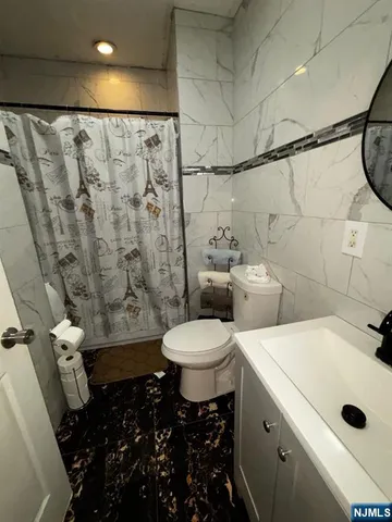 a large kitchen with a refrigerator and a dishwasher