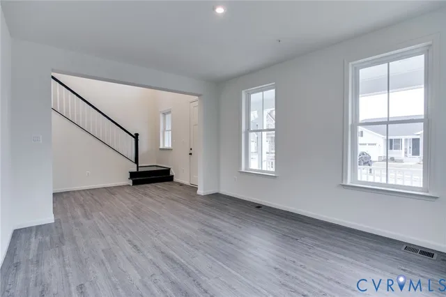an empty room with wooden floor