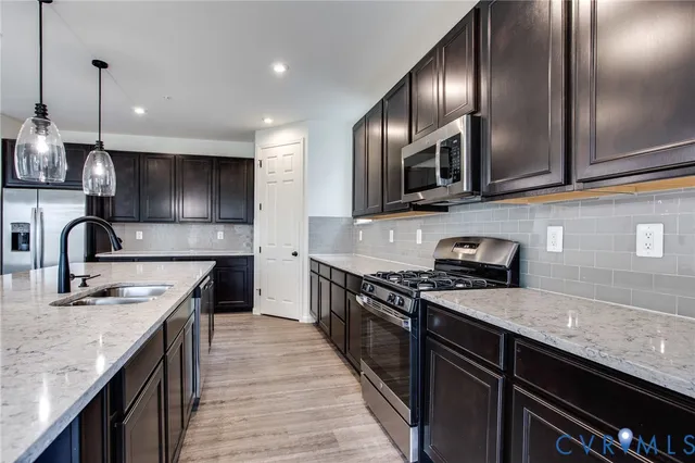 a kitchen with granite countertop stainless steel appliances and wooden cabinets