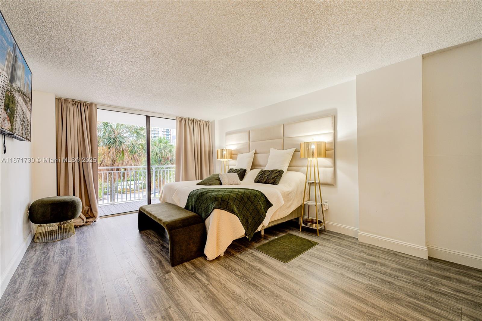 210 174th Street, Unit 312 Sunny Isles Beach, FL 33160 - Photo 13 of 16 a spacious bedroom with a bed and a large window