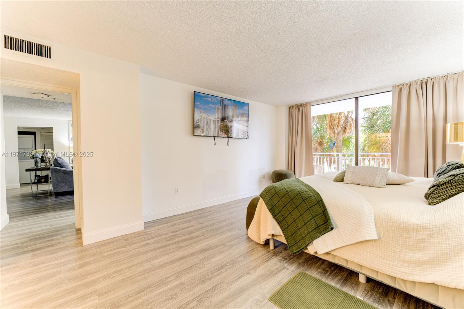 210 174th Street, Unit 312 Sunny Isles Beach, FL 33160 - Photo 16 of 16 a bedroom with a bed and a large window