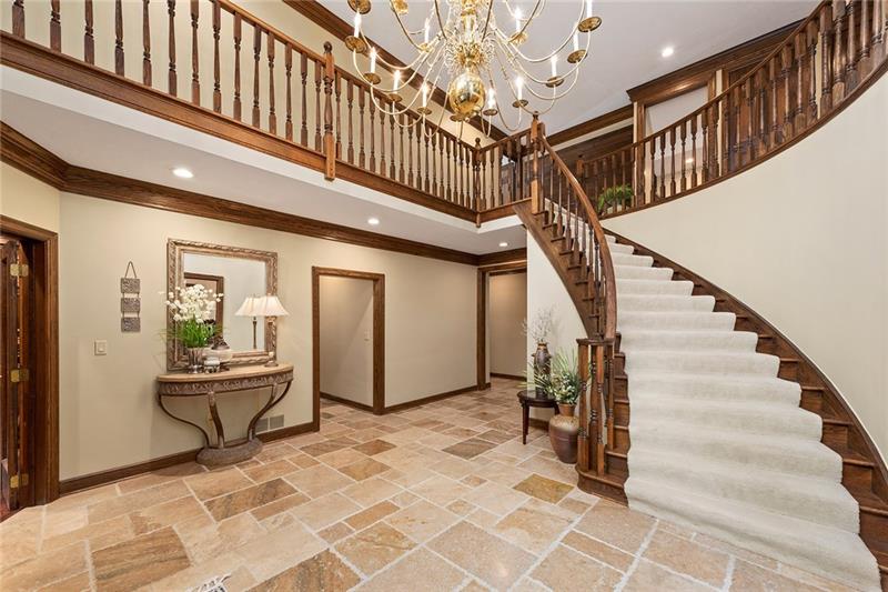 212 Mingo Road Wexford, PA 15090 - Photo 3 of 25 The formal two-story foyer features a spiral staircase and travertine floors