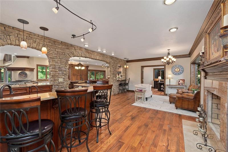 212 Mingo Road Wexford, PA 15090 - Photo 5 of 25 A parlor with wet bar, decorative stone wall fireplace introduces the many levels of entertaining in this home