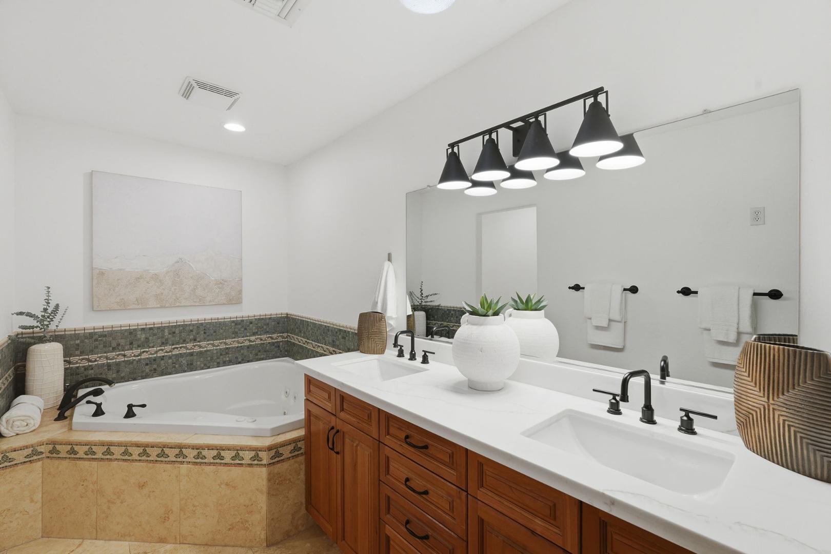 6302 East Cochise Road Paradise Valley, AZ 85253 - Photo 12 of 58 a bathroom with a tub sink and mirror