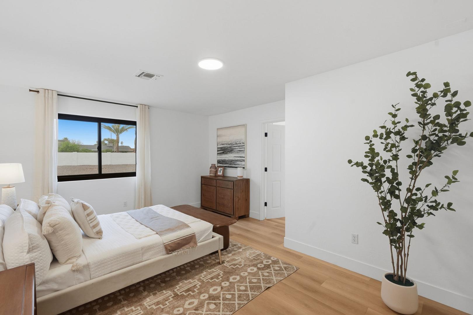 6302 East Cochise Road Paradise Valley, AZ 85253 - Photo 30 of 58 a bedroom with a large bed and a potted plant